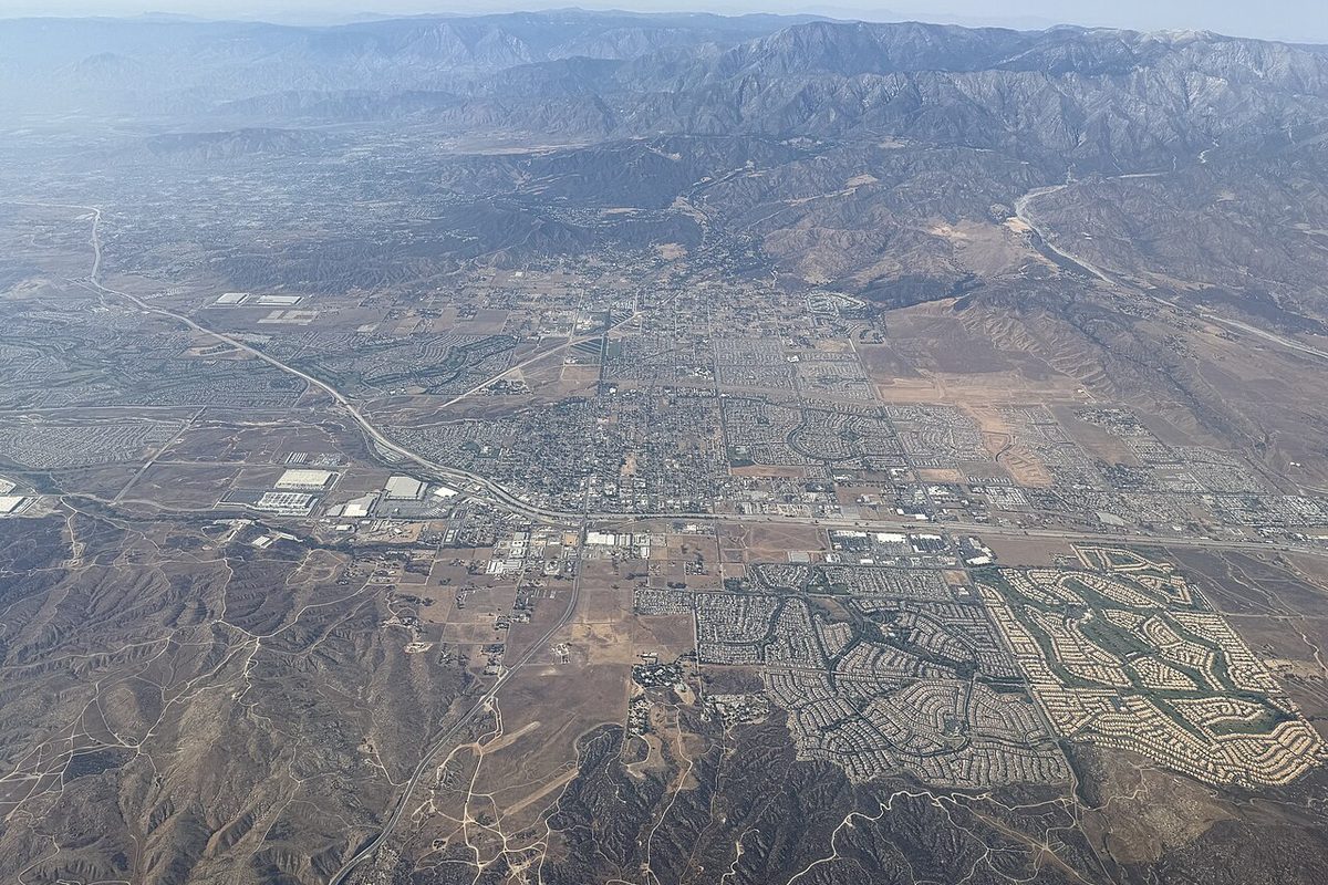 Aerial view over the Calimesa, Cherry Valley and Beaumont area of Riverside County, California, with mountains in the distance