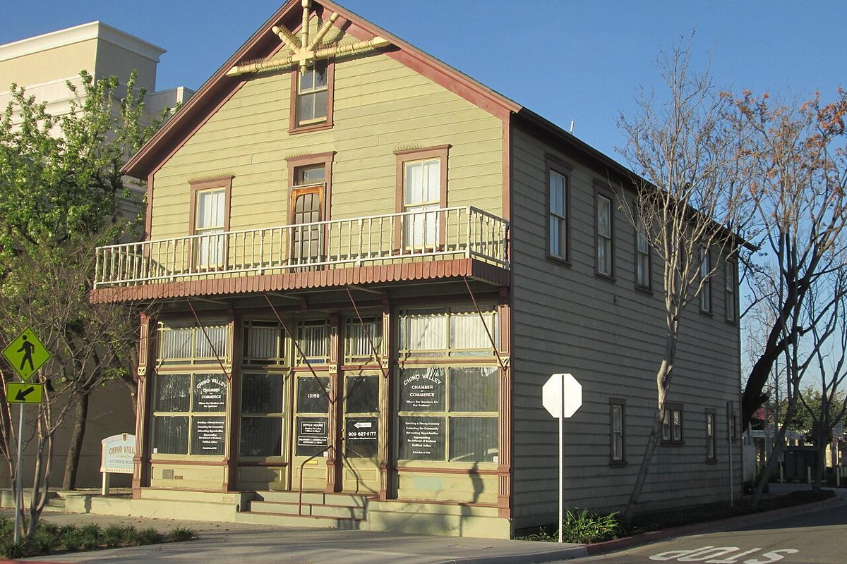 The historic Moyse Building, a two-story wood-frame building on a corner in Chino, California