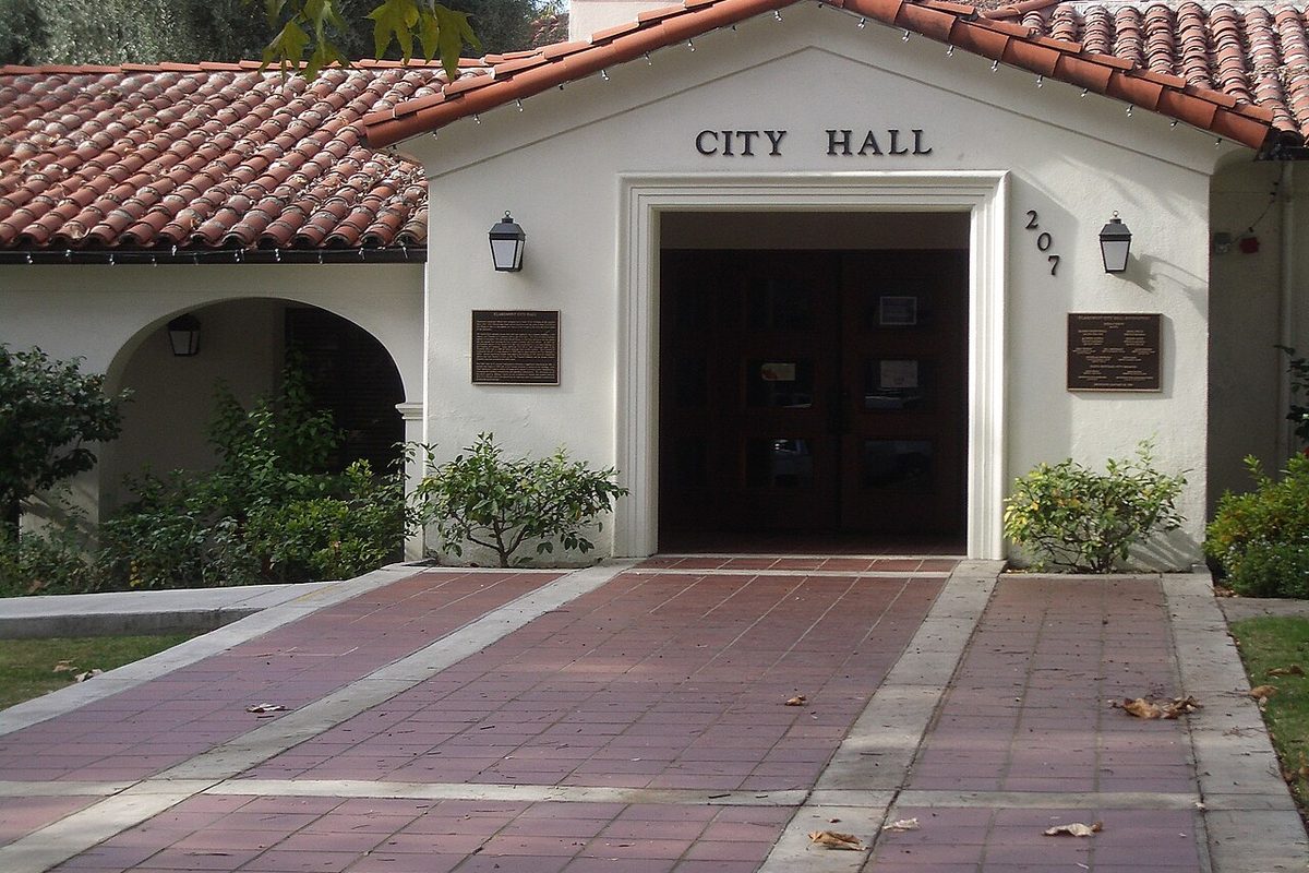 Entrance of Claremont City Hall, a white stucco building with a red tile roof, in Claremont, California