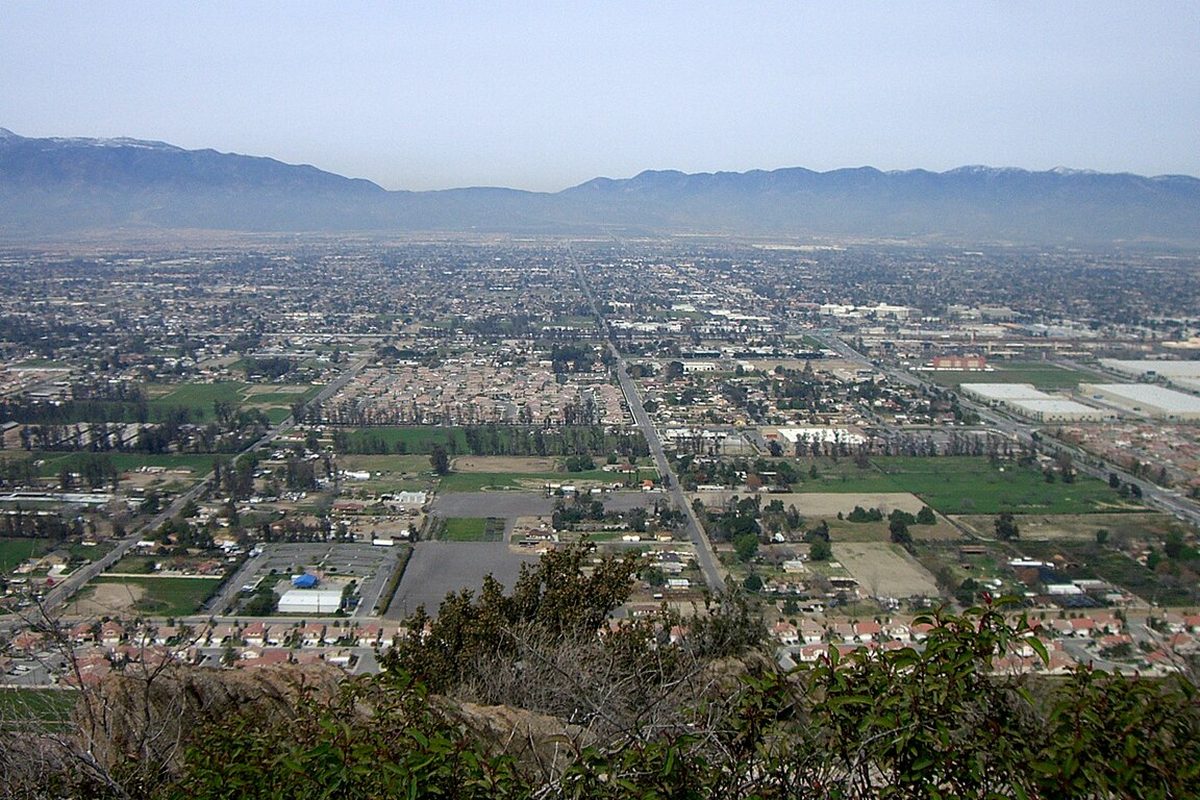 View over Fontana, California, from a hillside with mountains on the horizon