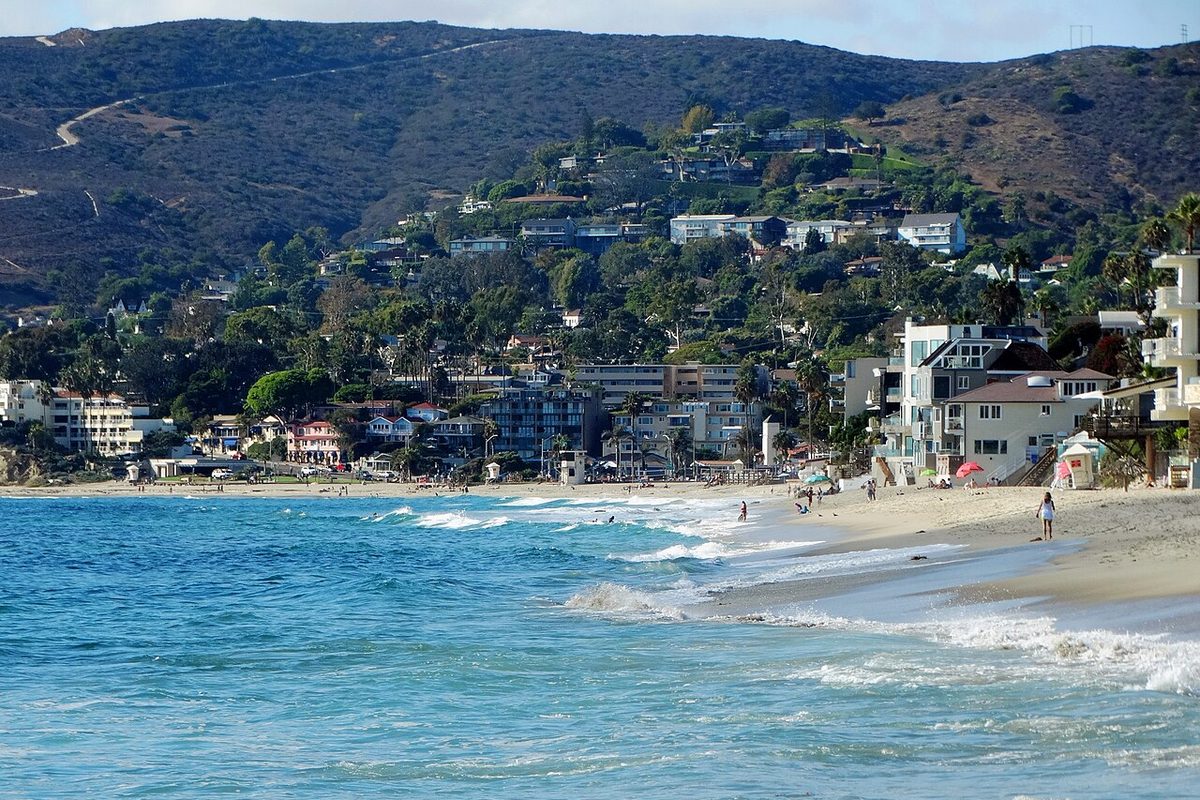 Homes on the hillside above the main beach and surf in Laguna Beach, California