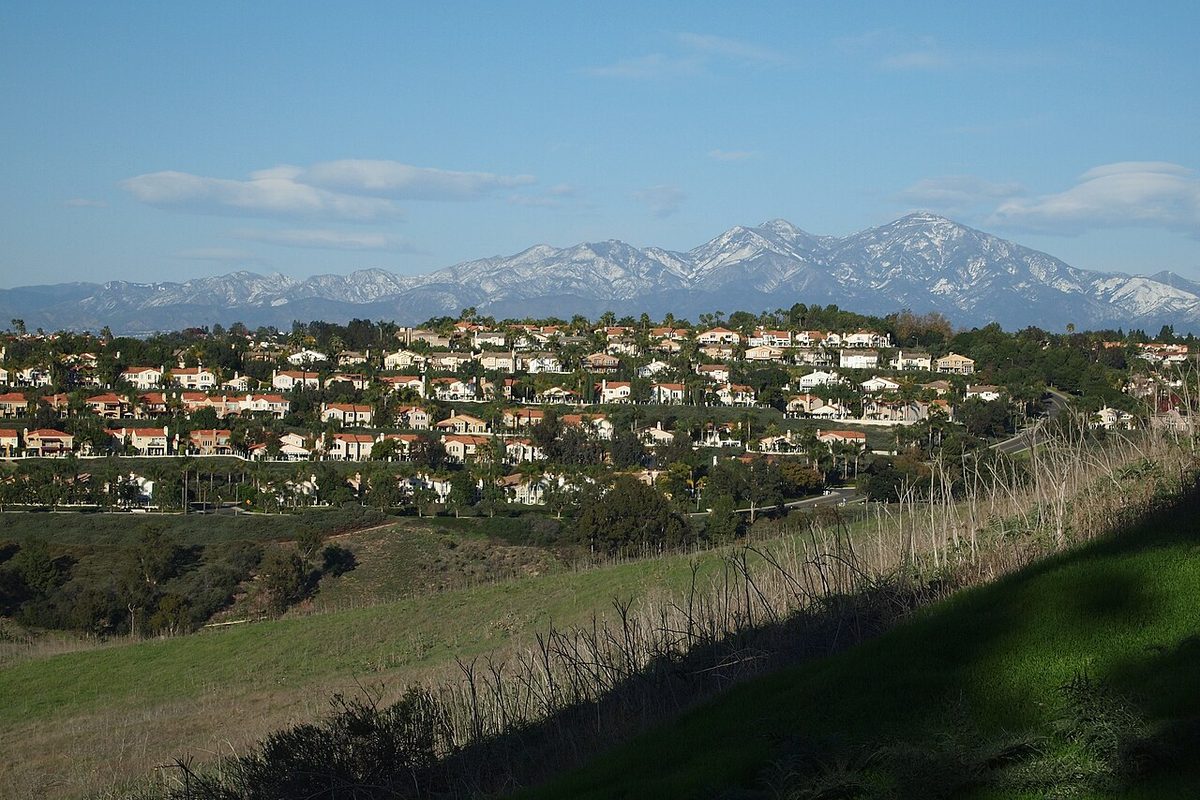 Hillside homes in Laguna Niguel, California, with the snow-capped Santa Ana Mountains behind