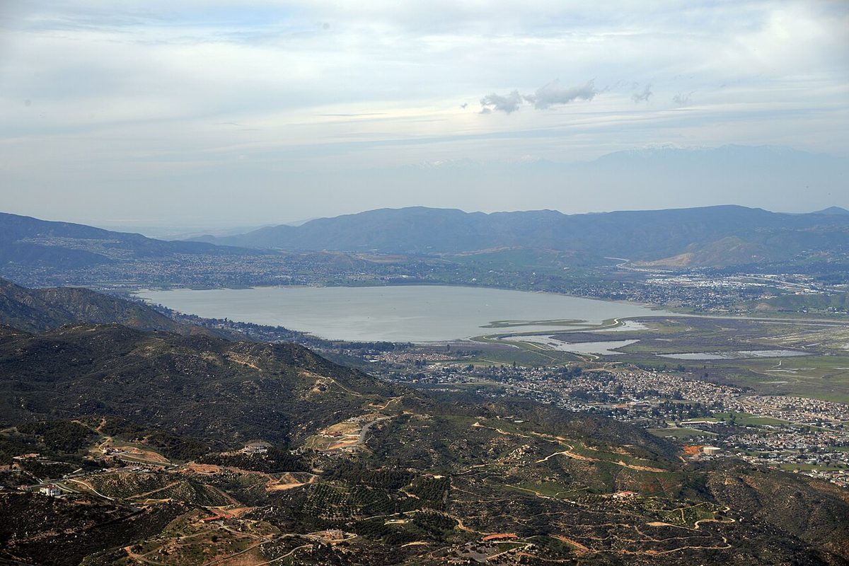 Aerial view of Lake Elsinore and the city of Lake Elsinore, California, surrounded by mountains