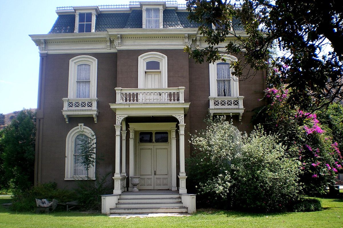 The historic Phillips Mansion, a brick house with a mansard roof, in Pomona, California