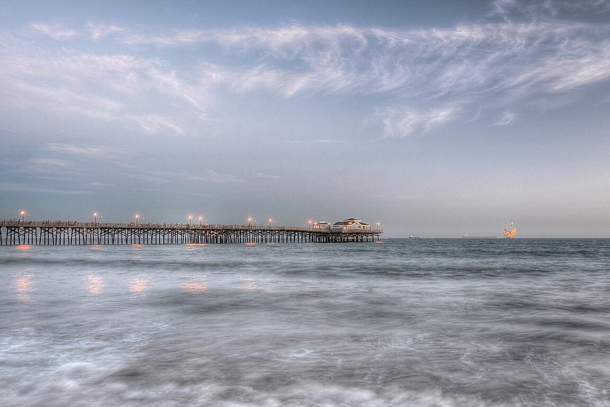 Seal Beach Pier at dusk over the ocean in Seal Beach, California